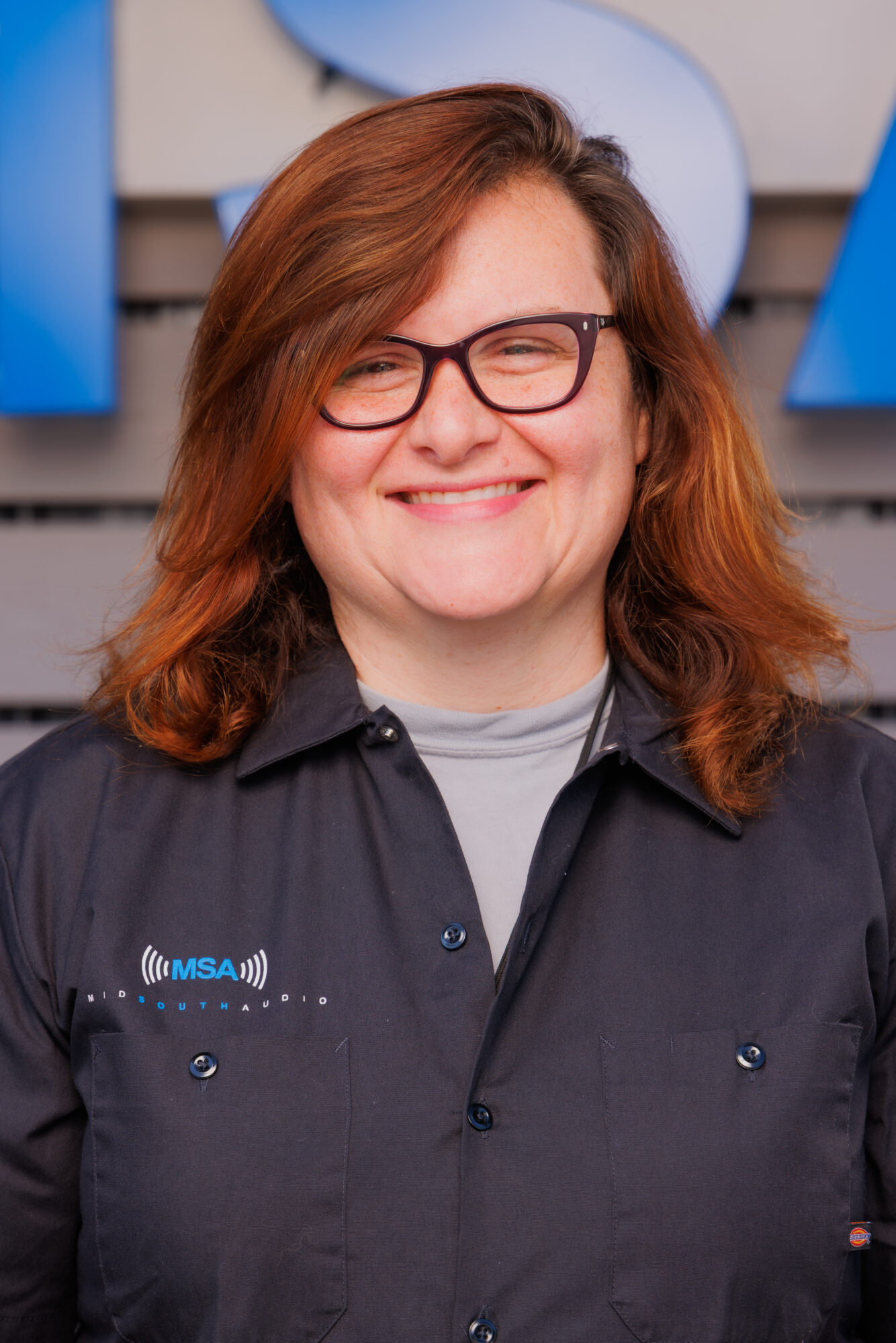 Catherine Henry Smiling woman wearing glasses and an MSA branded shirt